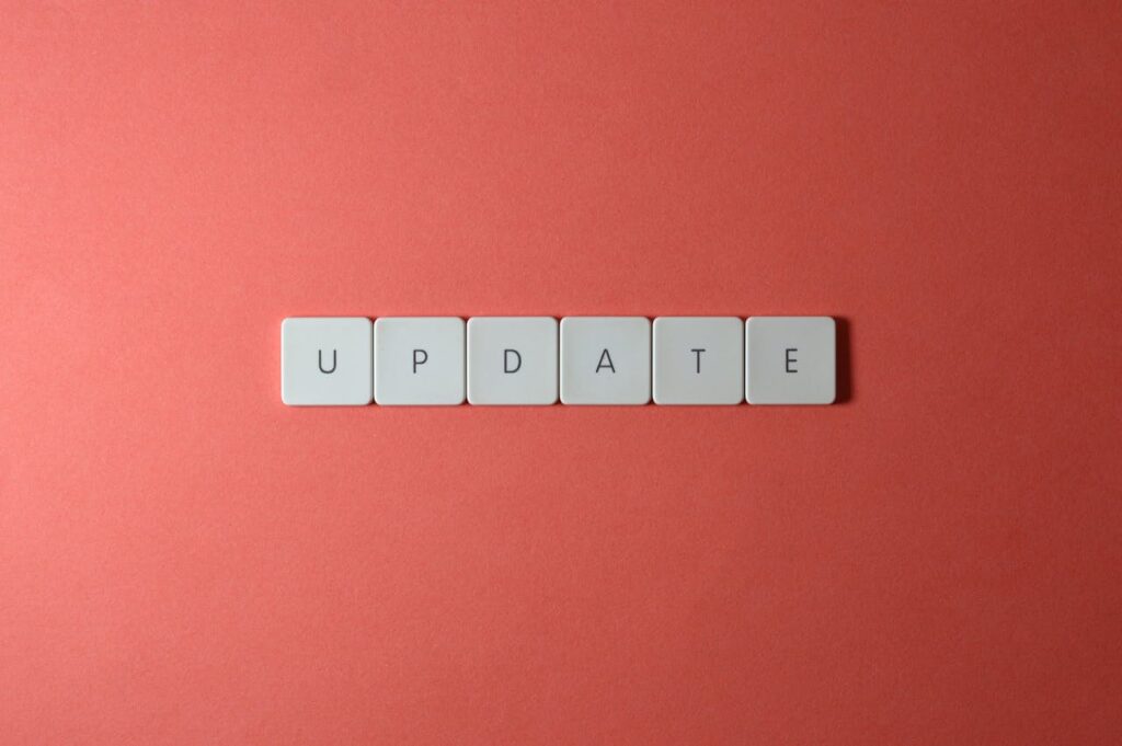 Keyboard keys arranged to spell 'update' on a vibrant red background, ideal for conveying tech concepts.